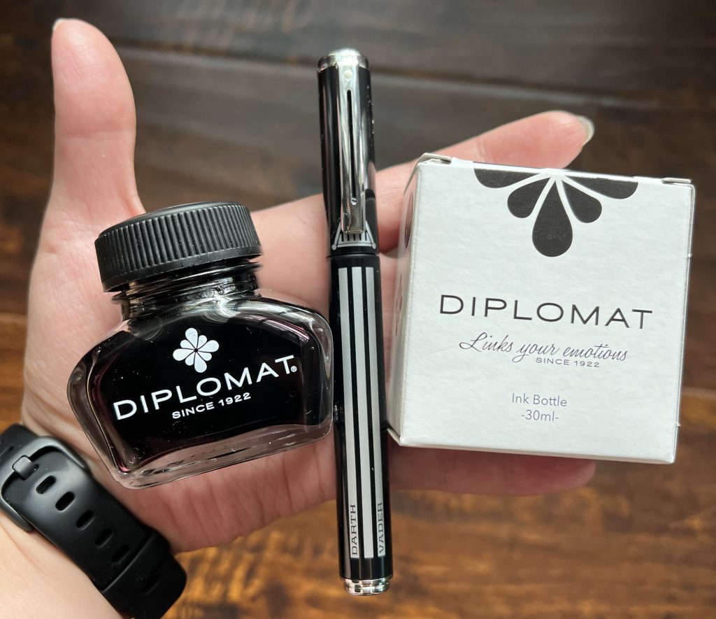 Diplomat Black ink bottle, shaeffer darth vader fountain pen, and ink packaging