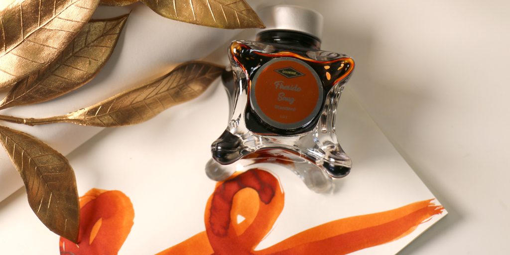 Diamine Fireside Snug ink review with bottle, ink swatch, and writing sample.