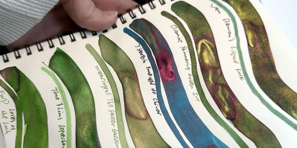 Green ink with gold shimmer ink comparison featuring 6 inks including J. Herbin Emerald of Chivor ink.
