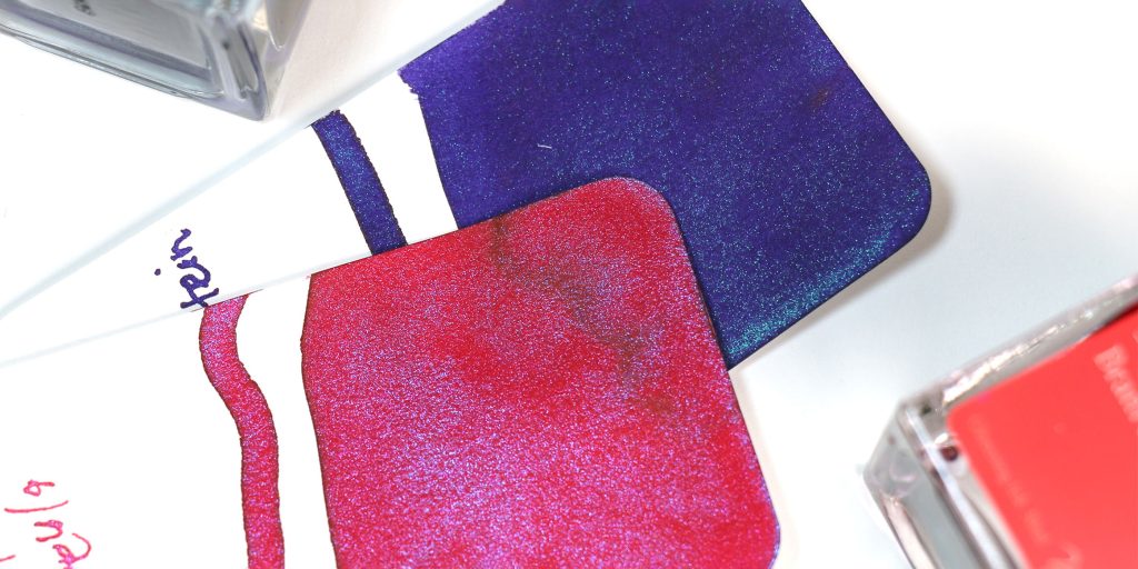 2 col-o-ring ink swatch test cards featuring the 2 inks, Wearingeul Dracula (crimson shimmer ink) and Wearingeul Frankenstein (purple shimmer ink). 