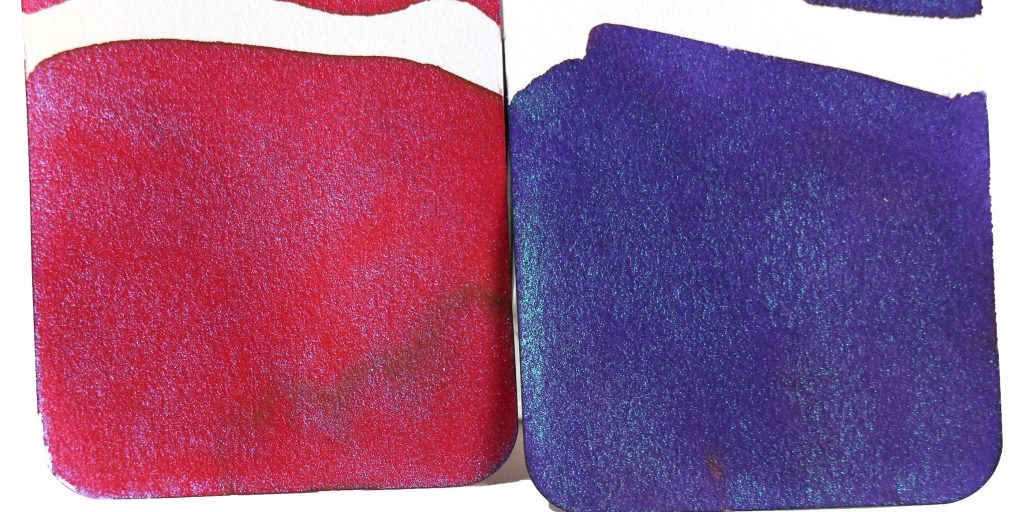 Wearingeul Dracula ink swatch (crimson base with icy blue shimmer) and Wearingeul Frankenstein ink swatch (strong purple base and pearly blue shimmer that creates a mossy illusion) both on Col-o-ring ink swatch cards. 