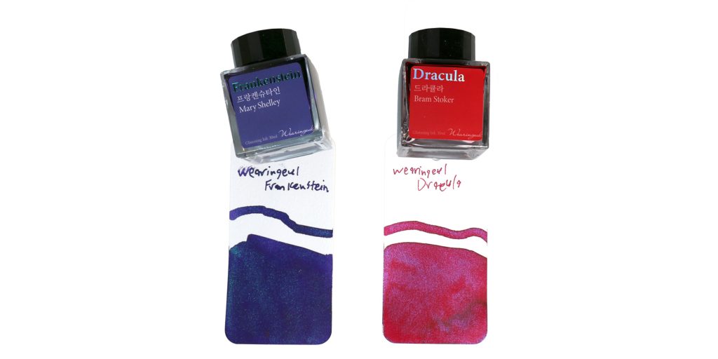 Wearingeul Frankenstein and Dracula ink bottles resting on Col-o-ring swatch cards with ink samples, white background