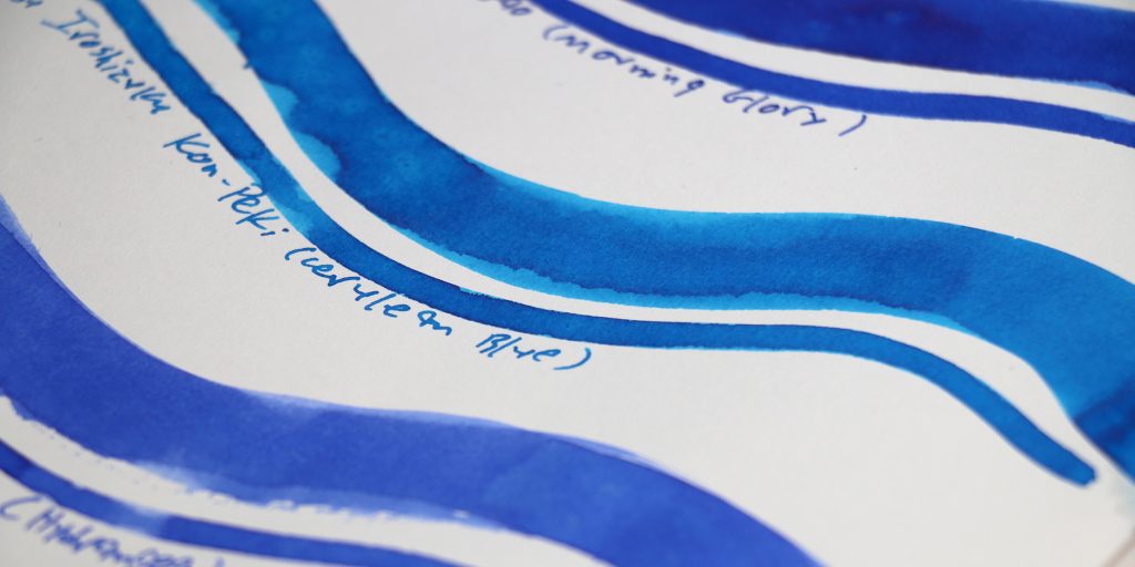 Close-up of Sailor Shikiori vs Iroshizuku blue ink swatches showing color variation