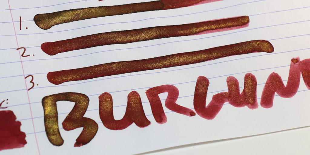 Close-up of The Great Sage Heaven’s Equal ink cotton swab tests with visible gold shimmer