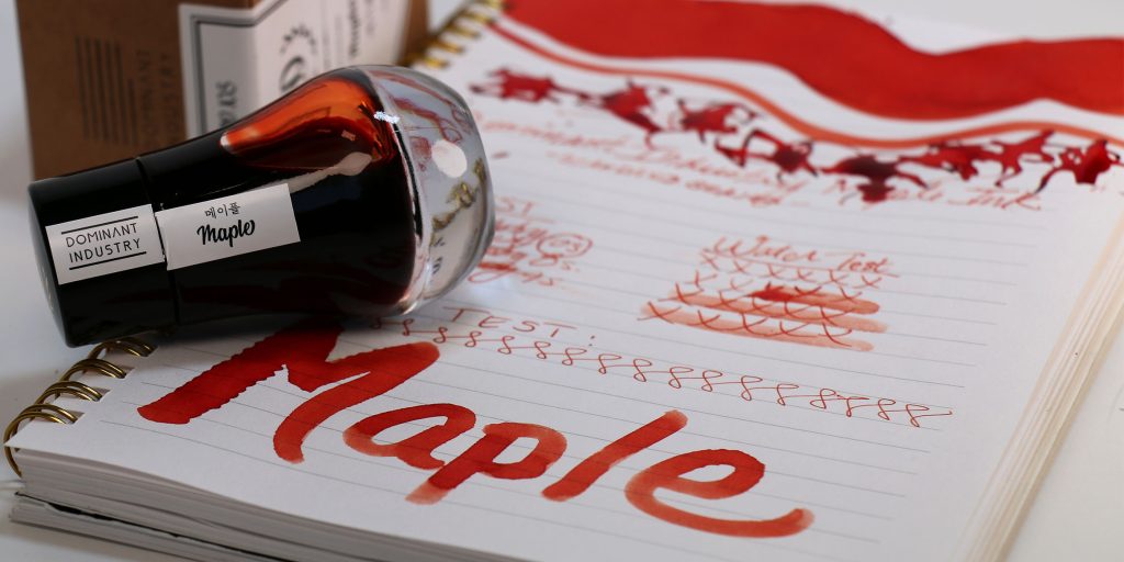 The Maple Ink Review test results with the ink bottle on its side in front of the Maple ink box/packaging. 