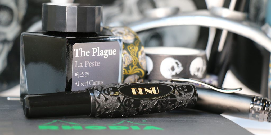 Wearingeul The Plague fountain pen ink bottle with BENU Jolly Roger Pixie fountain pen in black skull design.