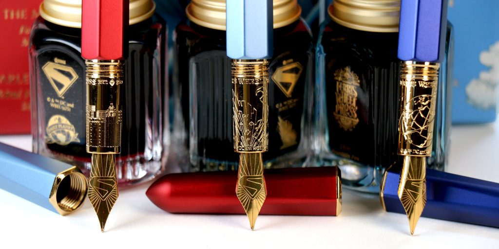 Superman Collection Marquis fountain pens with engraved gold nibs displayed in a close-up view.