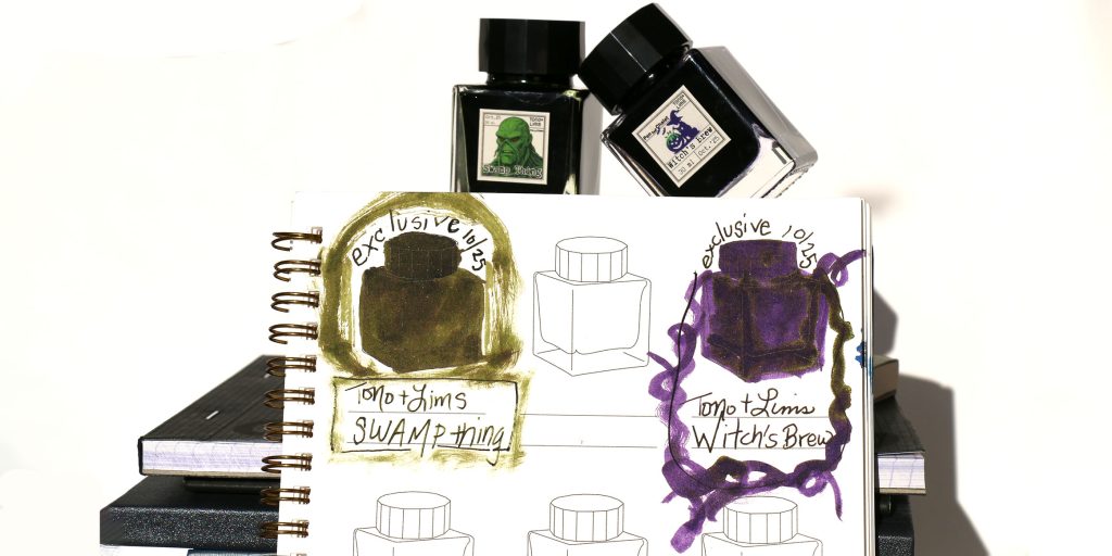 Tono and Lims Swamp Thing and Witch's Brew ink bottles with ink swatch notebook resting up against them showing Swamp Thing, a murky, swampy green ink, and Witch's Brew, a deep purple with a magical sheen.