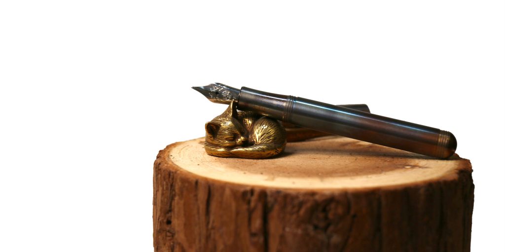 2025 Holiday gift guide for pens and inks and writing accessories: drop a sassy brassy pen rest in their stocking