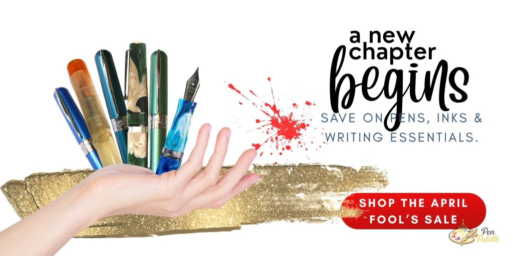 Hand holding fountain pens above gold brushstroke with text “A new chapter begins” and “Shop the April Fool’s Sale” for Pen Chalet’s Pen Palette promotion.