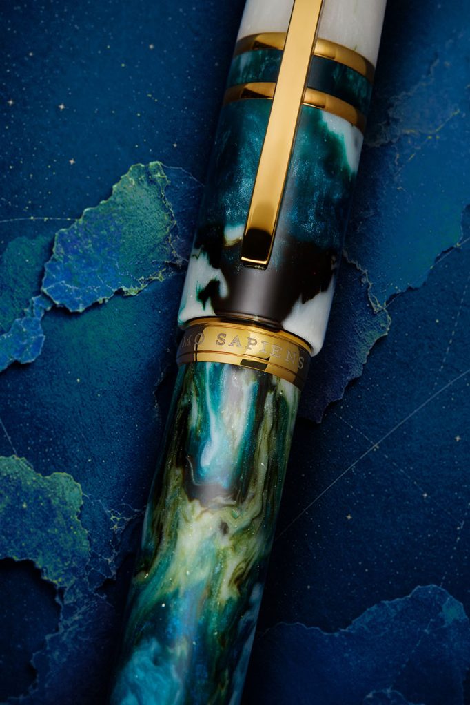 Closeup of the center ring and beautiful teal, black, white, and green swirled resin in the Visconti Homo Sapiens Nebula Eagle fountain pen, a luxury pen released in 2026.