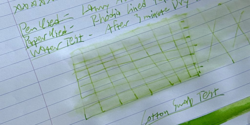 Diamine Appletini water test showing severely faded green ink lines after exposure to water.