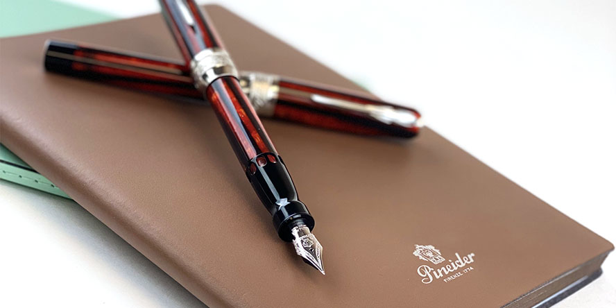 pineider_arco_firefox_fountain_pen_on_blues_notebook