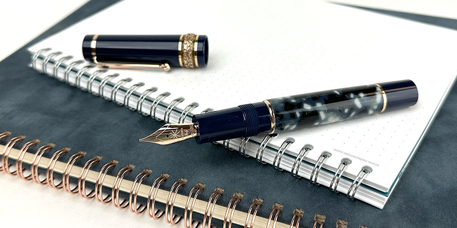 maiora_amalfi_rose_gold_fountain_pen_uncapped_on_notebooks