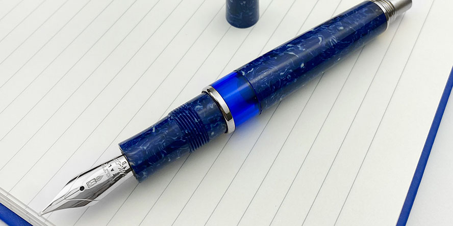 delta_lapis_blue_celluloid_le_188_fountain_pens_uncapped_on_lined_paper